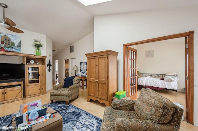 573 W Parkside Dr, Palatine, IL 60067 - living room with high vaulted ceiling, light wood-style floors, a skylight, and ceiling fan