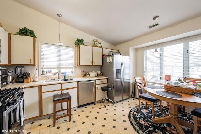 573 W Parkside Dr, Palatine, IL 60067 - kitchen featuring stainless steel appliances, light countertops, vaulted ceiling, pendant lighting, and light flooring