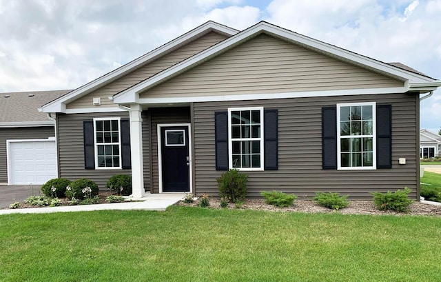 6471 Juniper Dr, Wonder Lake, IL 60097 - view of front of home with a front yard, an attached garage, and asphalt driveway