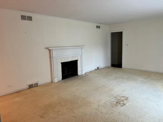 1917 Thornhill Rd, Inverness, IL 60067 - unfurnished living room featuring carpet flooring, a fireplace, and crown molding