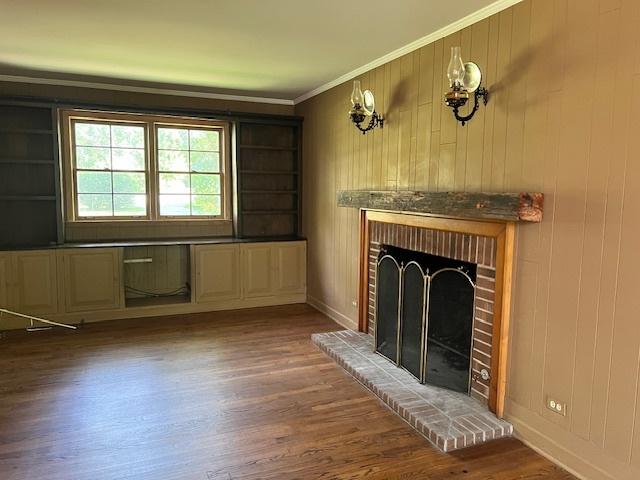 1917 Thornhill Rd, Inverness, IL 60067 - unfurnished living room featuring a fireplace, wood finished floors, crown molding, and wood walls