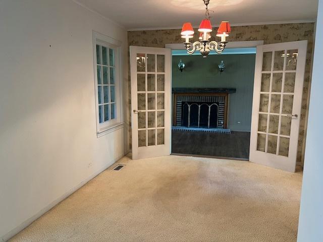 1917 Thornhill Rd, Inverness, IL 60067 - unfurnished living room featuring carpet flooring and a chandelier