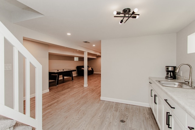 5246 N Mason Ave, Chicago, IL 60630 - bar area featuring light wood-style flooring, recessed lighting, stairway, and a chandelier