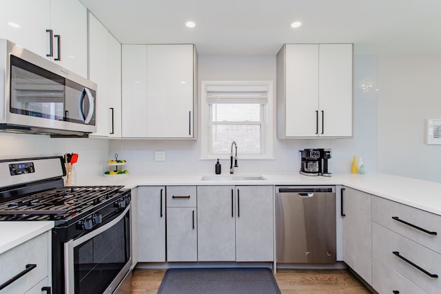 5246 N Mason Ave, Chicago, IL 60630 - kitchen with stainless steel appliances, light wood finished floors, modern cabinets, decorative backsplash, and recessed lighting