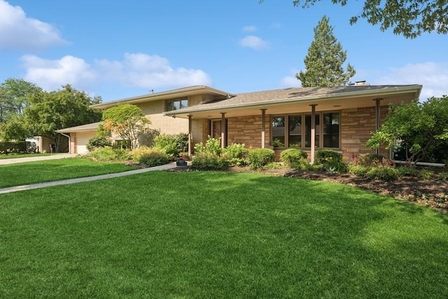 8850 Karlov Ave, Skokie, IL 60076 - view of front of home featuring a front lawn, stone siding, an attached garage, and driveway