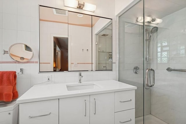 8850 Karlov Ave, Skokie, IL 60076 - full bathroom with a shower stall, vanity, and tile walls