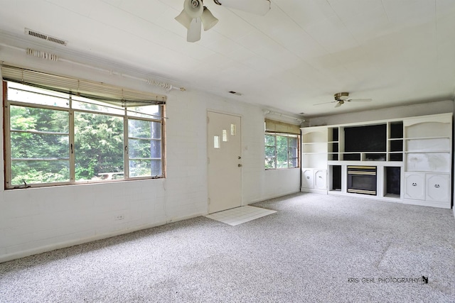 143 Eagle Point Rd, Fox Lake, IL 60020 - unfurnished living room featuring a ceiling fan, a fireplace, and concrete block wall
