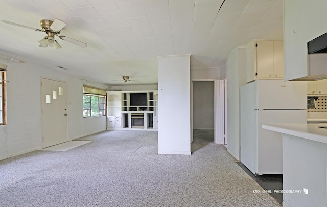 143 Eagle Point Rd, Fox Lake, IL 60020 - kitchen featuring freestanding refrigerator, a ceiling fan, a glass covered fireplace, light colored carpet, and light countertops