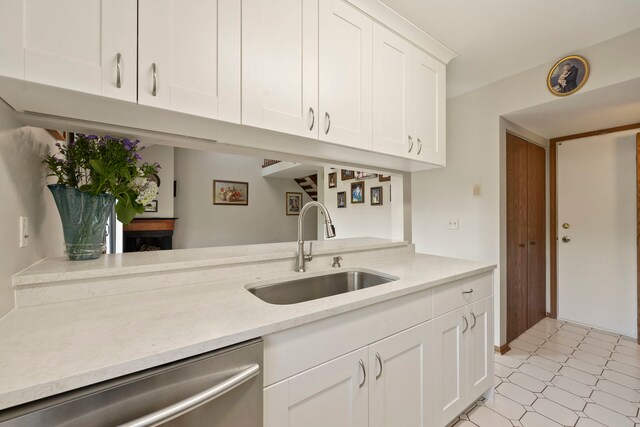 3072 Carlton Ct, Westchester, IL 60154 - kitchen featuring stainless steel dishwasher, white cabinetry, and light flooring