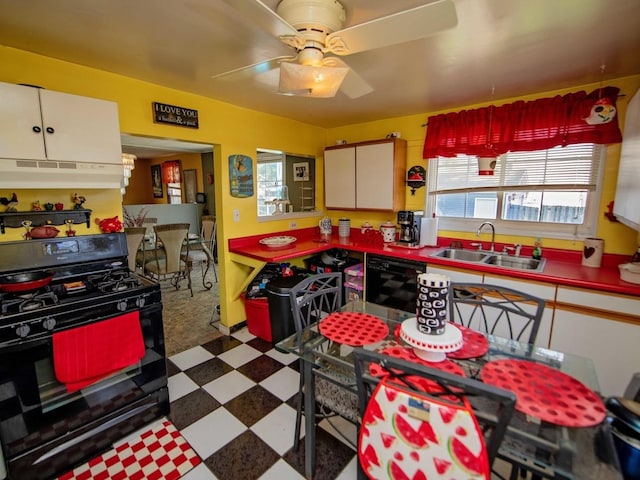 1742 N 34th Ave, Stone Park, IL 60165 - kitchen with black gas range oven, under cabinet range hood, tile patterned floors, and ceiling fan