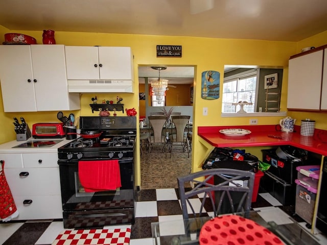 1742 N 34th Ave, Stone Park, IL 60165 - kitchen with black gas stove, under cabinet range hood, white cabinetry, and tile patterned floors