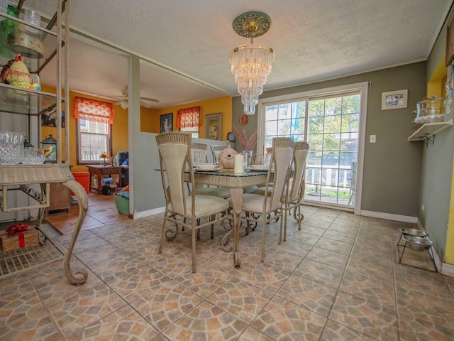1742 N 34th Ave, Stone Park, IL 60165 - dining space with a chandelier, stone finish floors, a ceiling fan, and a textured ceiling