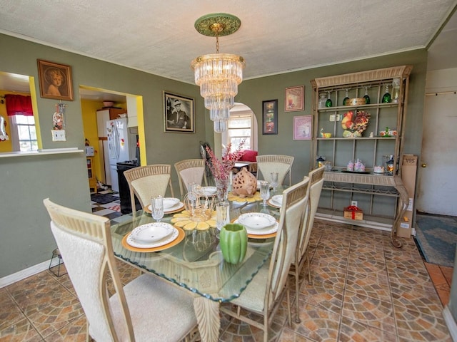 1742 N 34th Ave, Stone Park, IL 60165 - dining space featuring healthy amount of natural light, stone finish flooring, and a chandelier