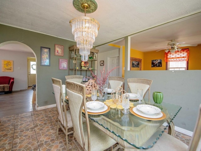 1742 N 34th Ave, Stone Park, IL 60165 - dining room with arched walkways, a ceiling fan, and a chandelier