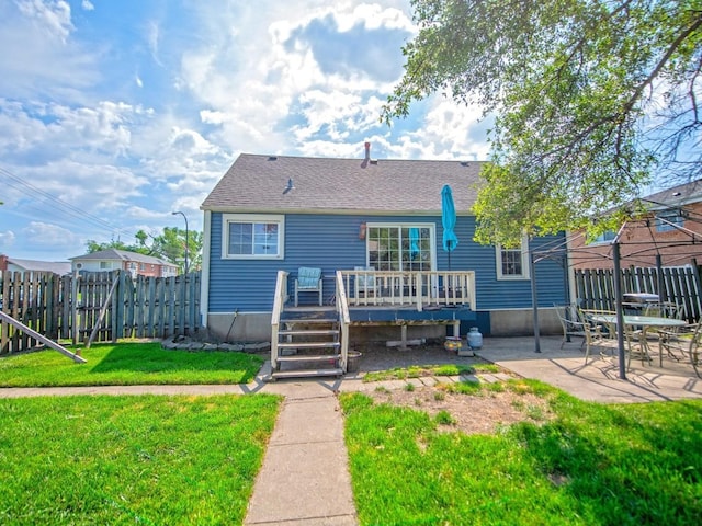 1742 N 34th Ave, Stone Park, IL 60165 - back of property featuring a deck, a patio area, and a shingled roof