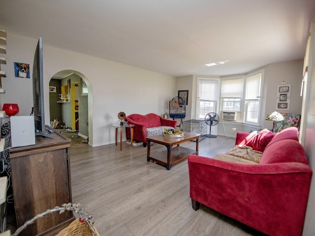 1742 N 34th Ave, Stone Park, IL 60165 - living area featuring light wood finished floors, arched walkways, and cooling unit