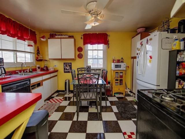 1742 N 34th Ave, Stone Park, IL 60165 - kitchen featuring dark flooring, healthy amount of natural light, black appliances, and a ceiling fan