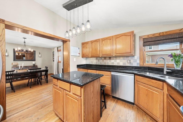 9912 S Kolmar Ave, Oak Lawn, IL 60453 - kitchen featuring stainless steel dishwasher, a chandelier, light wood finished floors, a kitchen island, and backsplash