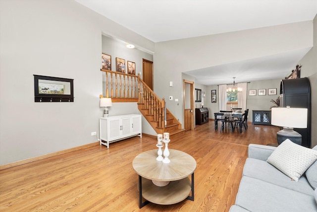 9912 S Kolmar Ave, Oak Lawn, IL 60453 - living room featuring a chandelier, stairway, and light wood-type flooring