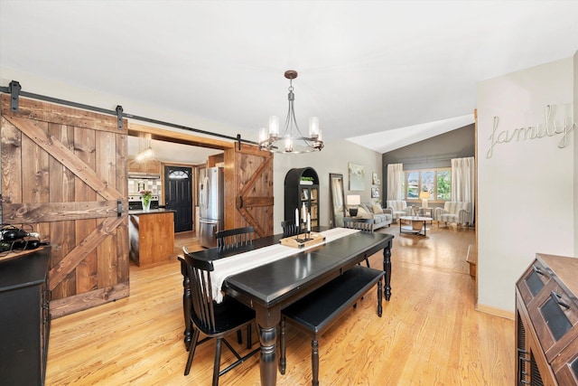9912 S Kolmar Ave, Oak Lawn, IL 60453 - dining space featuring a barn door, light wood-style flooring, lofted ceiling, a chandelier, and arched walkways