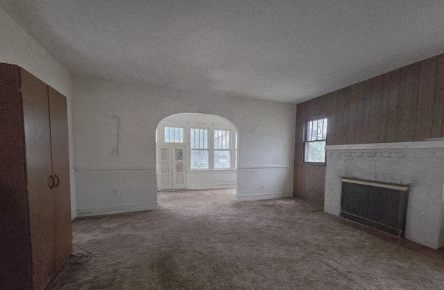 434 S Lewis Ave, Lombard, IL 60148 - unfurnished living room featuring a brick fireplace, a textured ceiling, carpet, and a wainscoted wall