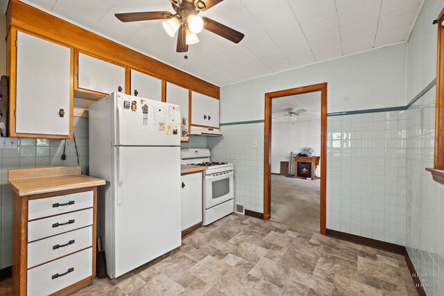 3715 Maple Ave, Mchenry, IL 60050 - kitchen with white appliances, ceiling fan, under cabinet range hood, tile walls, and light countertops