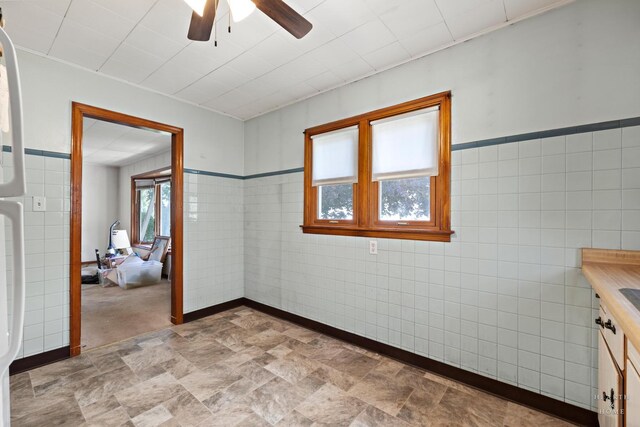 3715 Maple Ave, Mchenry, IL 60050 - empty room with a ceiling fan, stone finish flooring, and tile walls