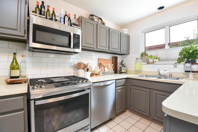 801 S Plymouth Ct Unit V, Chicago, IL 60605 - kitchen with appliances with stainless steel finishes, gray cabinets, light countertops, decorative backsplash, and light tile patterned floors