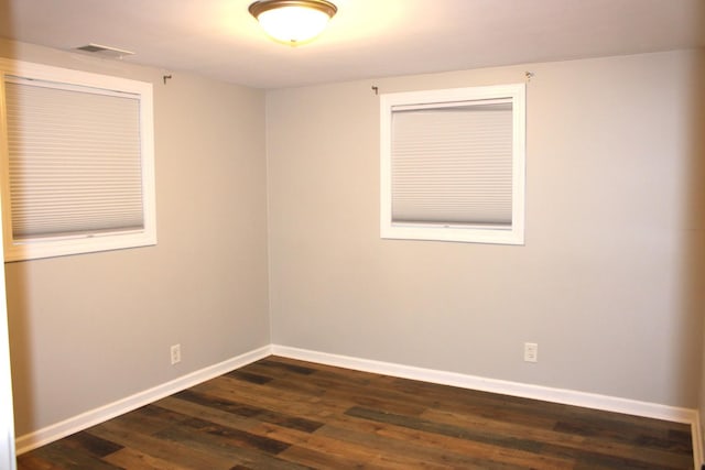 309 Bass St, Wilmington, IL 60481 - empty room featuring baseboards and dark wood finished floors