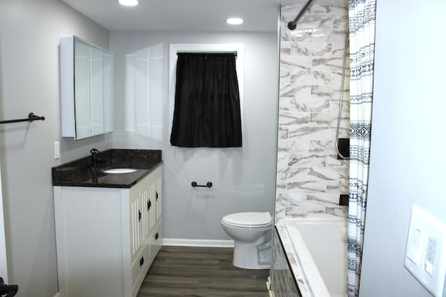 309 Bass St, Wilmington, IL 60481 - bathroom featuring vanity, wood finished floors, tiled shower / bath, and recessed lighting