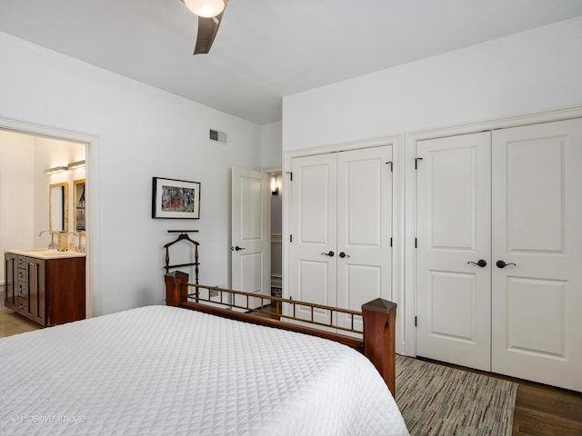 1416 W Olive Ave Unit 1, Chicago, IL 60660 - bedroom with multiple closets, dark wood finished floors, a ceiling fan, and ensuite bath