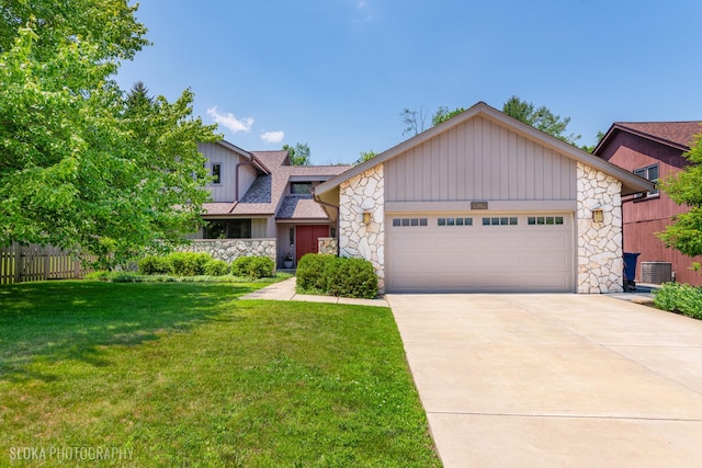 530 Sunnyside Ave, Gurnee, IL 60031 - mid-century home with stone siding, an attached garage, driveway, board and batten siding, and roof with shingles