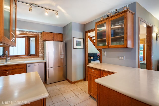 530 Sunnyside Ave, Gurnee, IL 60031 - kitchen with stainless steel appliances, brown cabinetry, light countertops, and light tile patterned floors