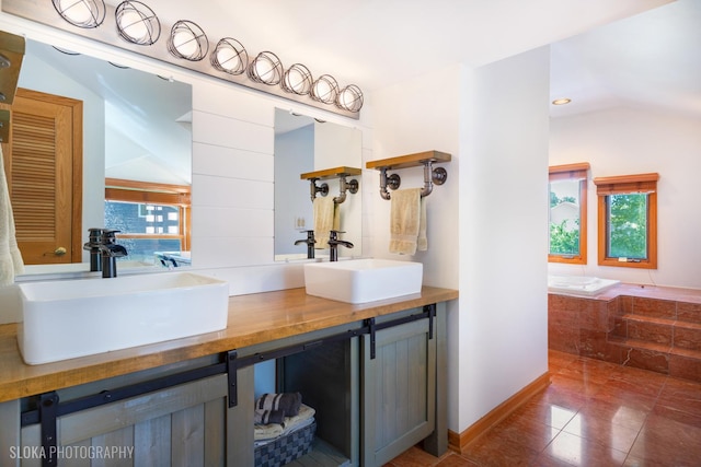 530 Sunnyside Ave, Gurnee, IL 60031 - full bathroom with double vanity, vaulted ceiling, and tile patterned floors