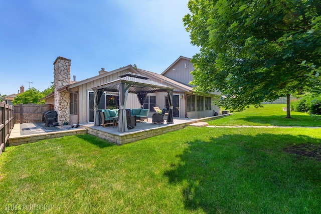 530 Sunnyside Ave, Gurnee, IL 60031 - back of property with a chimney, an outdoor hangout area, a gazebo, and a patio area