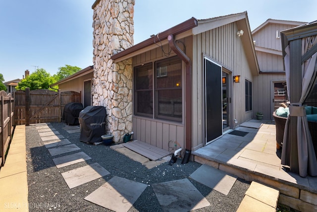 530 Sunnyside Ave, Gurnee, IL 60031 - exterior space with board and batten siding, a gate, a chimney, and a patio area