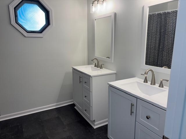 20031 Scott St, Mokena, IL 60448 - full bathroom featuring two vanities and baseboards