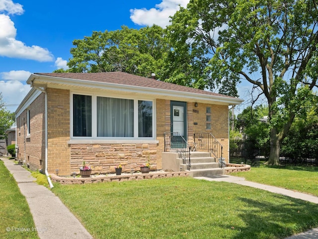 3318 Wilder St, Skokie, IL 60076 - bungalow with a front yard, brick siding, and stone siding