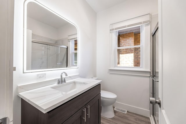 8510 S Blackstone Ave, Chicago, IL 60619 - full bath featuring vanity, a stall shower, plenty of natural light, and wood finished floors
