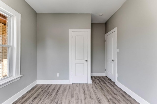 8510 S Blackstone Ave, Chicago, IL 60619 - unfurnished bedroom with wood finished floors and baseboards