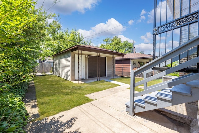 8510 S Blackstone Ave, Chicago, IL 60619 - view of patio with a detached garage, an outbuilding, and driveway