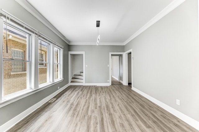 8510 S Blackstone Ave, Chicago, IL 60619 - spare room featuring wood finished floors, ornamental molding, and stairs