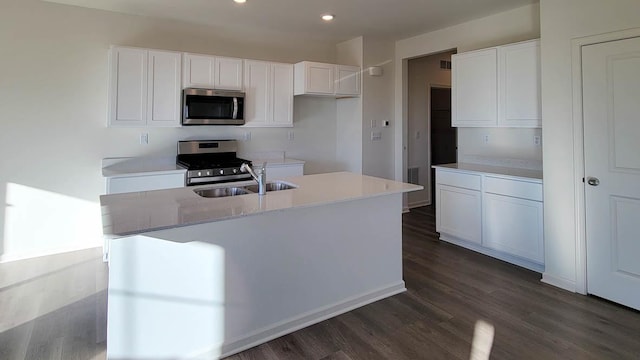 6475 Juniper Dr, Wonder Lake, IL 60097 - kitchen featuring appliances with stainless steel finishes, dark wood-type flooring, white cabinetry, recessed lighting, and a kitchen island with sink
