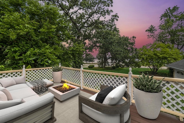 691 Lake Ave, Crystal Lake, IL 60014 - deck at dusk featuring an outdoor living space with a fire pit