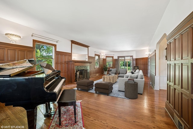 691 Lake Ave, Crystal Lake, IL 60014 - living room featuring light wood-style floors, a decorative wall, wainscoting, a fireplace, and plenty of natural light