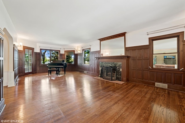 691 Lake Ave, Crystal Lake, IL 60014 - living room featuring a decorative wall, a high end fireplace, wood finished floors, and a wainscoted wall