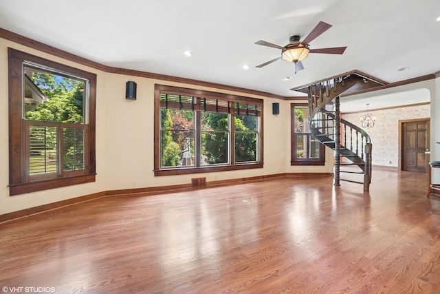 691 Lake Ave, Crystal Lake, IL 60014 - unfurnished living room featuring stairway, healthy amount of natural light, ornamental molding, wood finished floors, and ceiling fan