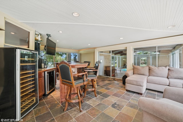 691 Lake Ave, Crystal Lake, IL 60014 - living room with beverage cooler, a bar, stone tile floors, and recessed lighting