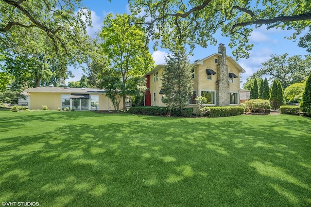 691 Lake Ave, Crystal Lake, IL 60014 - back of house with a chimney and a yard