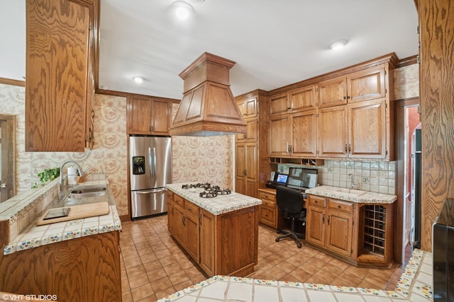 691 Lake Ave, Crystal Lake, IL 60014 - kitchen featuring stainless steel fridge with ice dispenser, built in desk, white gas stovetop, backsplash, and custom exhaust hood